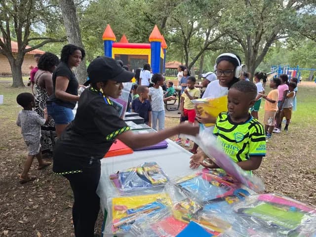 THC volunteers giving out school supplies at a community event
